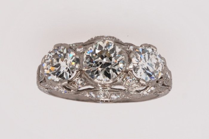 Antique three-stone diamond ring with filigree detail