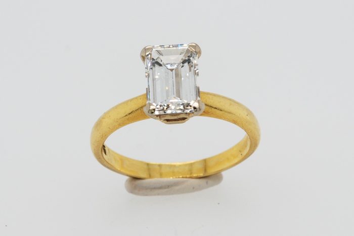 Emerald-cut diamond solitaire ring in yellow gold