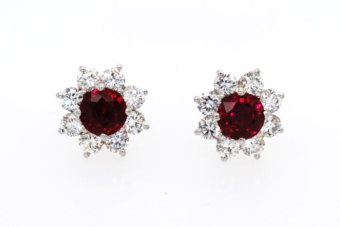 Pair of red gemstone earrings surrounded by diamonds