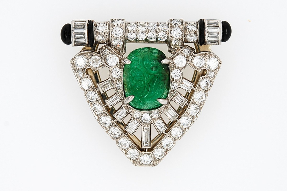 Antique Art Deco platinum dress clip with a carved emerald, diamonds, and black onyx
