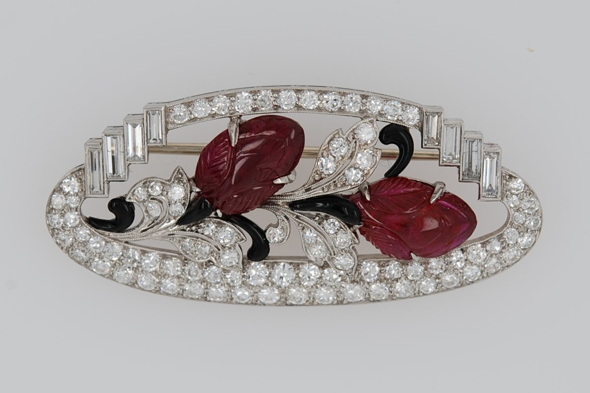 Antique platinum Art Deco brooch with two carved rubies, black enamel, and diamonds