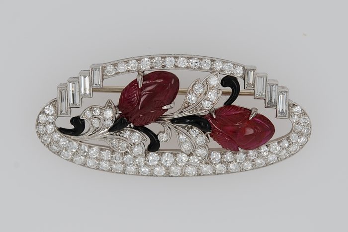 Art Deco platinum brooch with carved red gemstones, black onyx, and diamonds