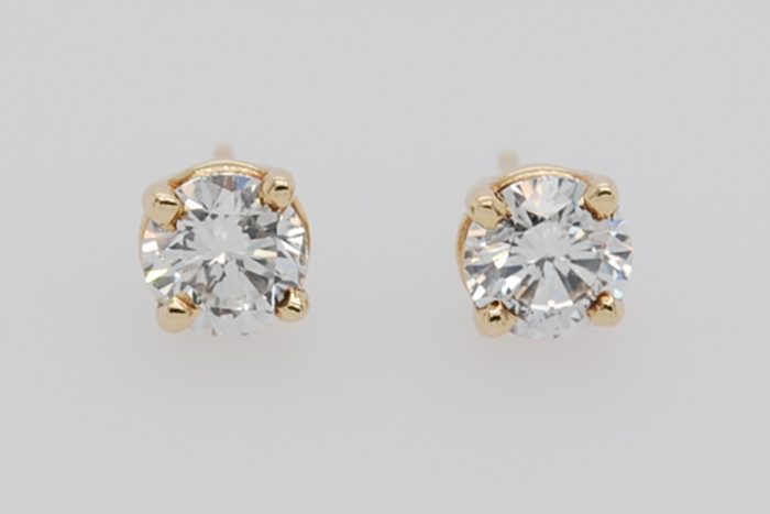 Pair of diamond stud earrings in yellow gold