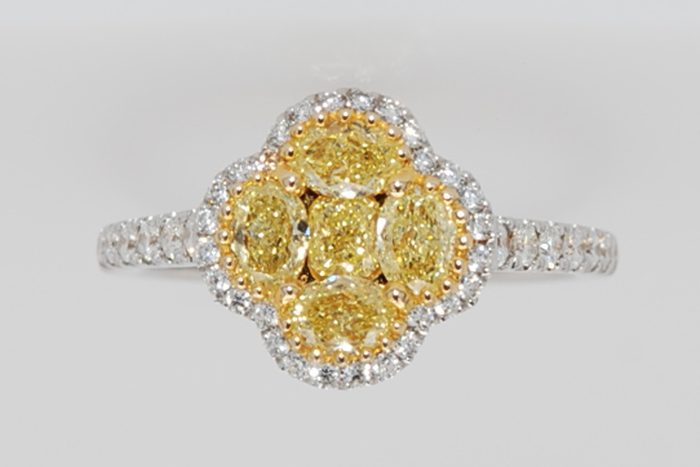 Yellow diamond cluster ring with a diamond halo