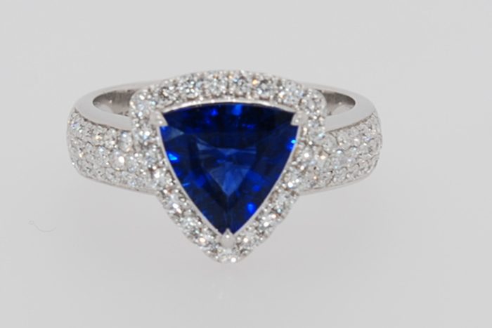 Blue gemstone ring with a diamond halo