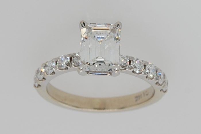 Emerald-cut diamond ring with a diamond-set band