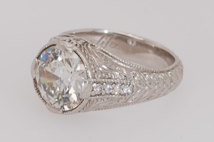 Antique-style diamond ring with engraved shoulders